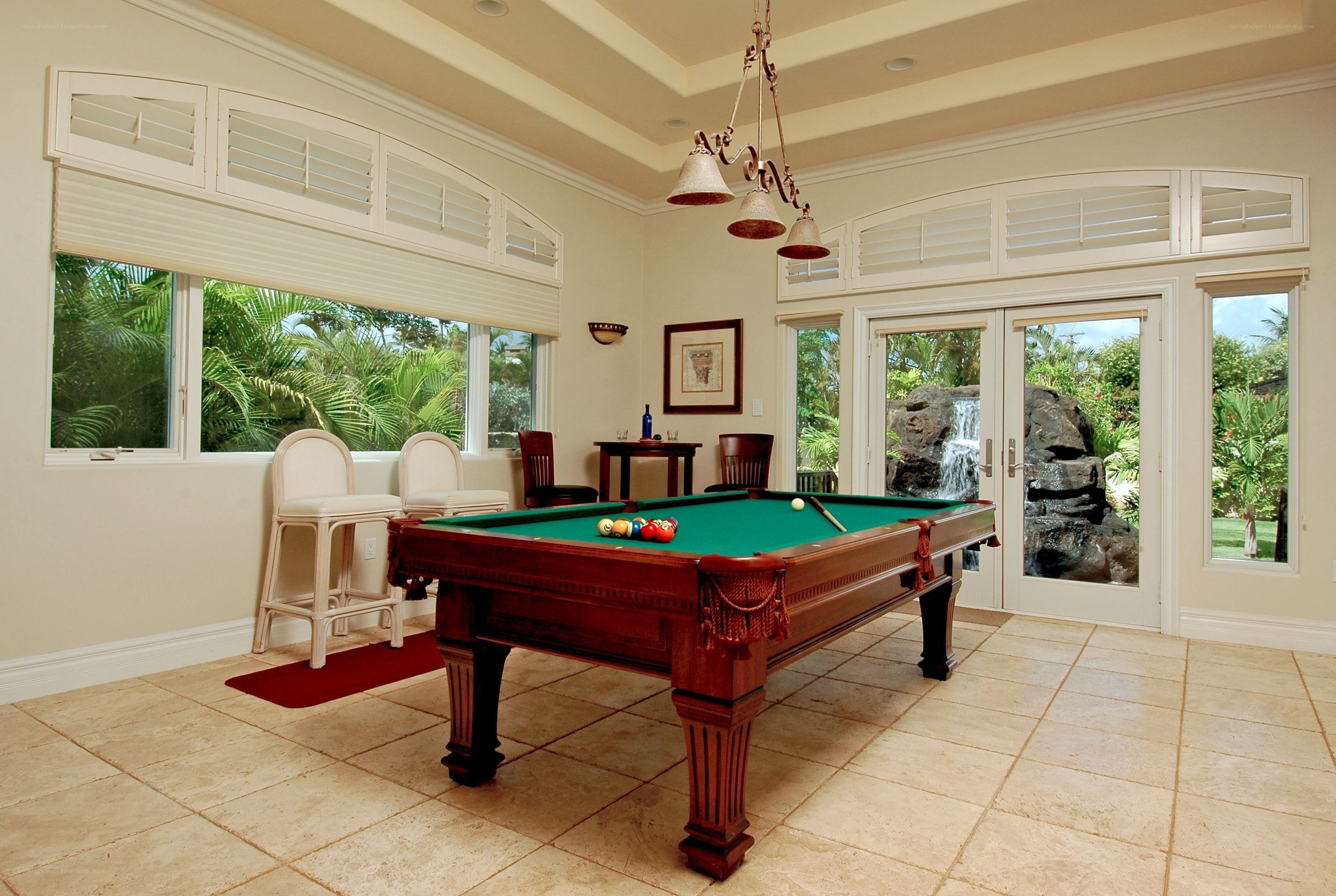 Pool table in sunroom with garden view