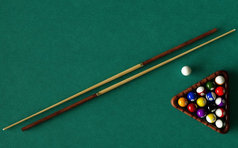 Pool table with balls and cues
