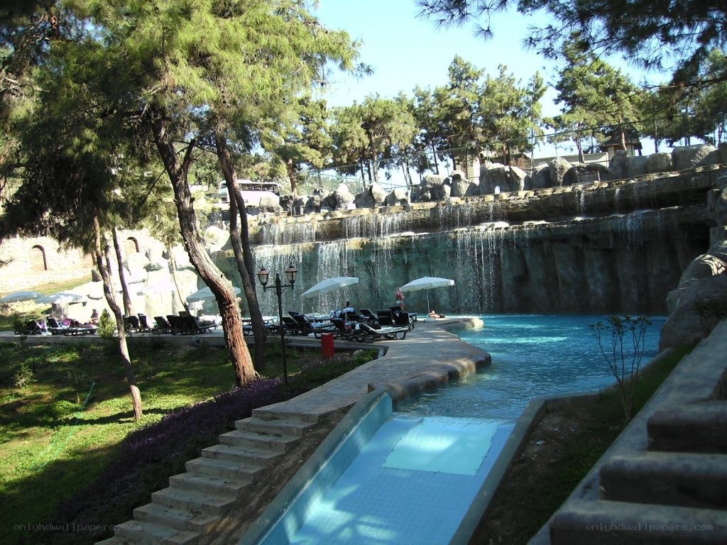 Pool with waterfall and lounge chairs