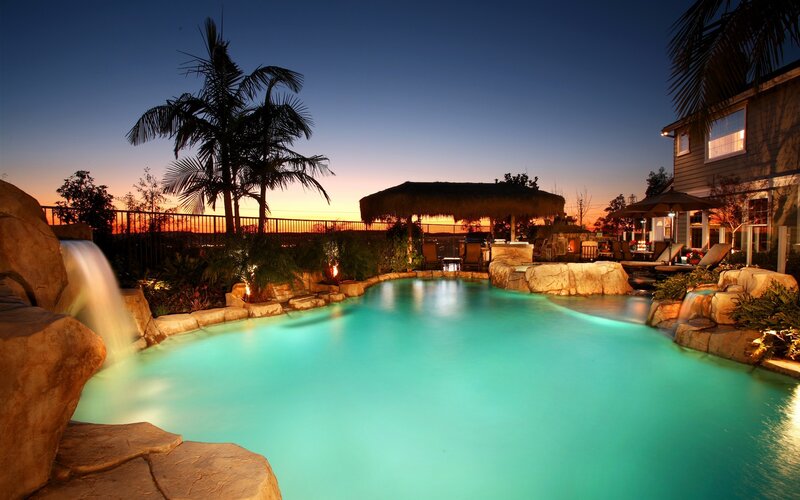 pool with waterfall at dusk
