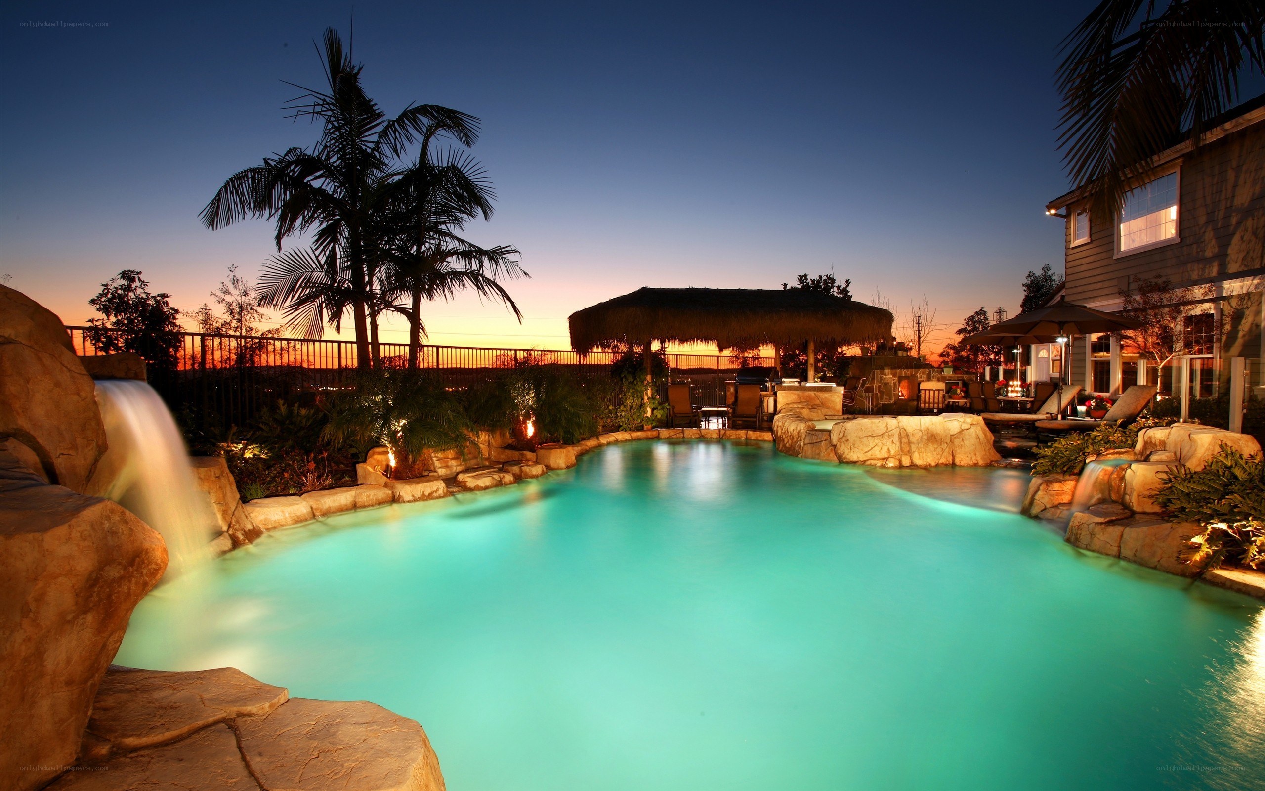 pool with waterfall at dusk