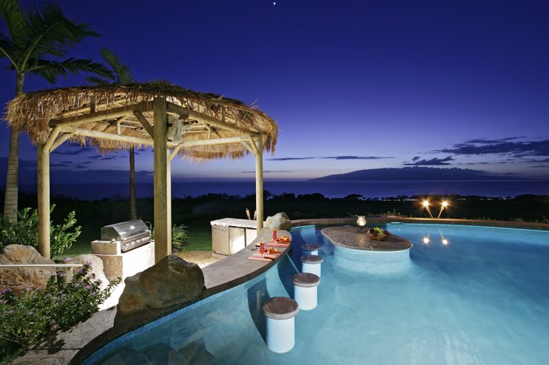 Poolside bar at dusk with ocean view