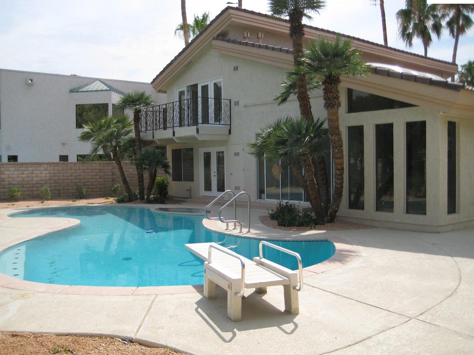 poolside house with palm trees