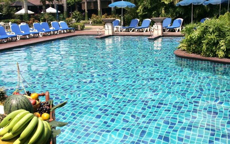 Poolside resort with fruit basket