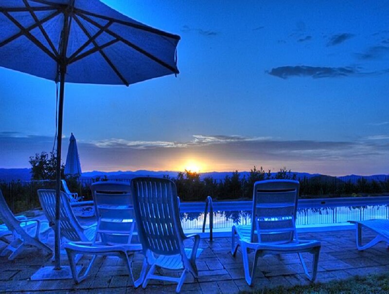 Poolside sunset with lounge chairs
