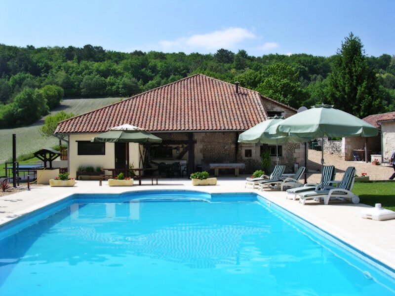 Poolside villa with green umbrellas