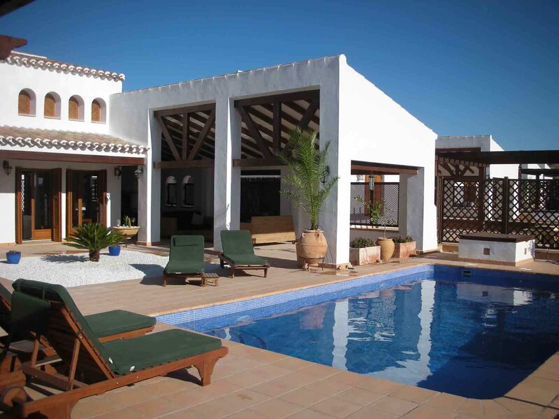 Poolside villa with lounge chairs