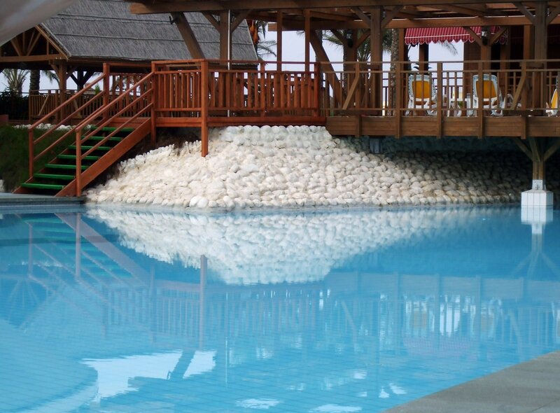 poolside wooden deck with lounge chairs