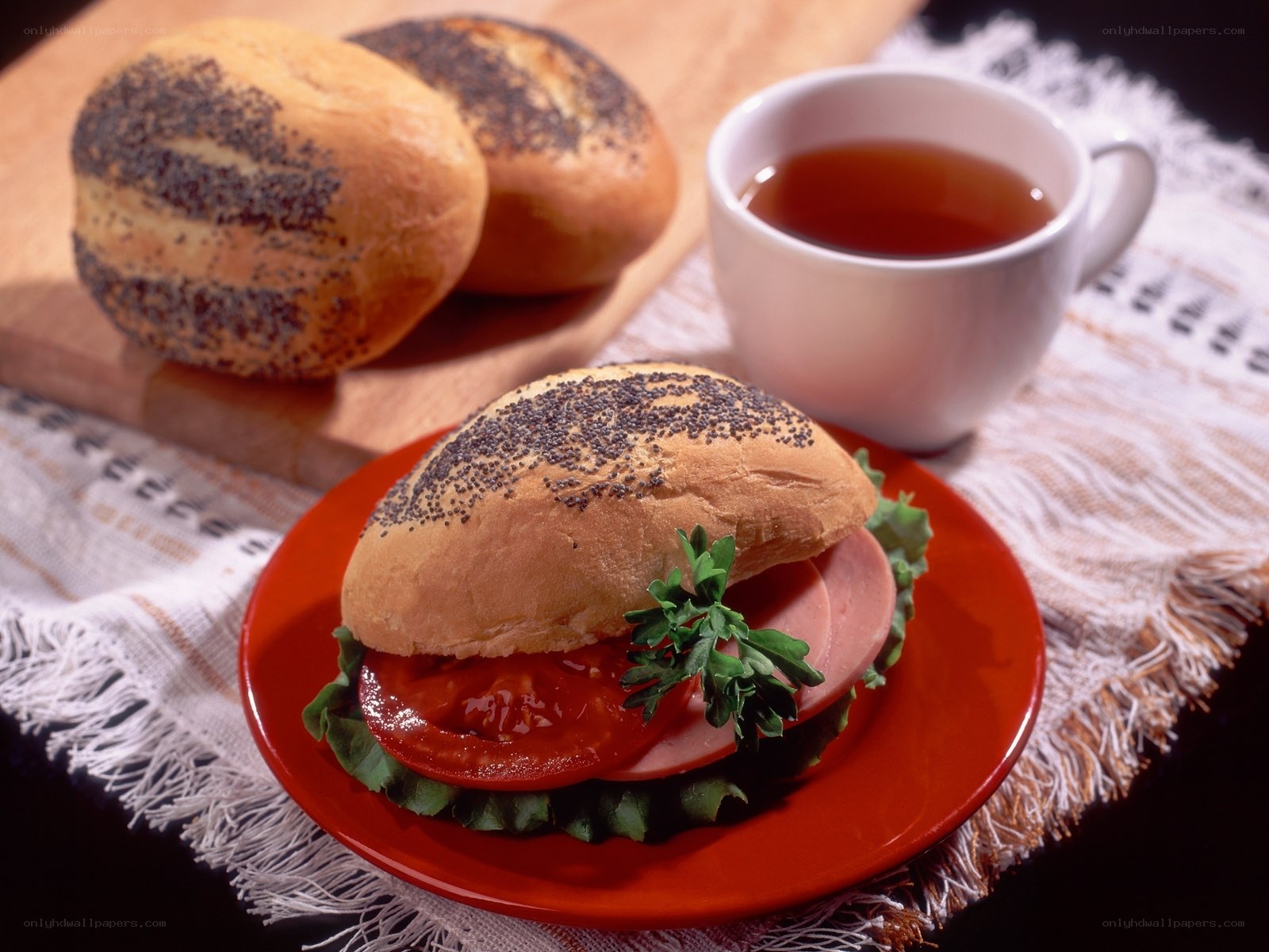 Poppy seed bun sandwich with tea
