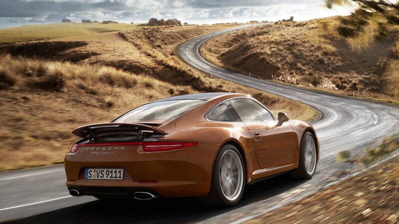 Porsche 911 Carrera driving on a winding road