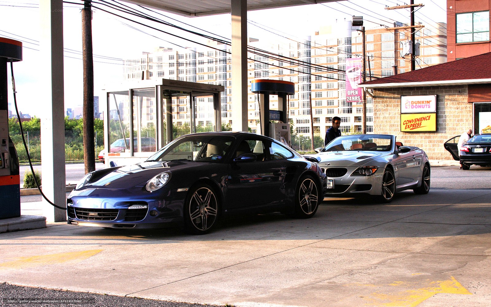 Porsche and BMW at gas station