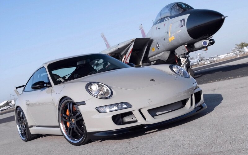 Porsche and fighter jet on tarmac