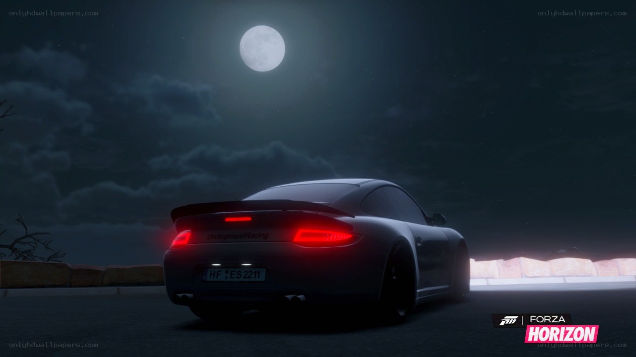 Porsche at night under moonlight