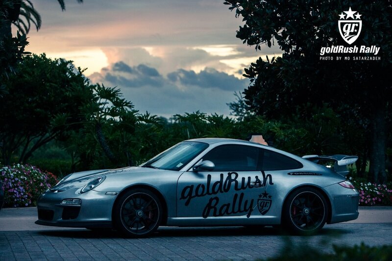 Porsche at sunset with rally branding