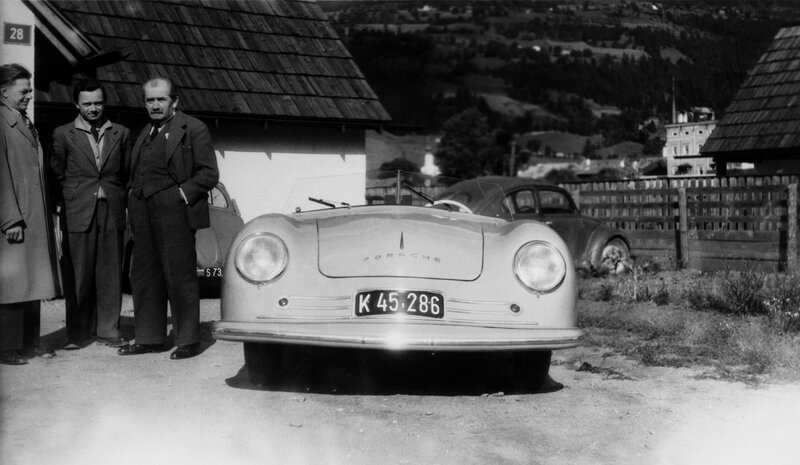 Porsche car with men in village