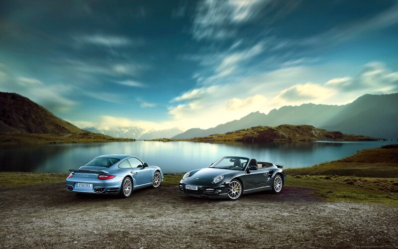 Porsche cars by a lake