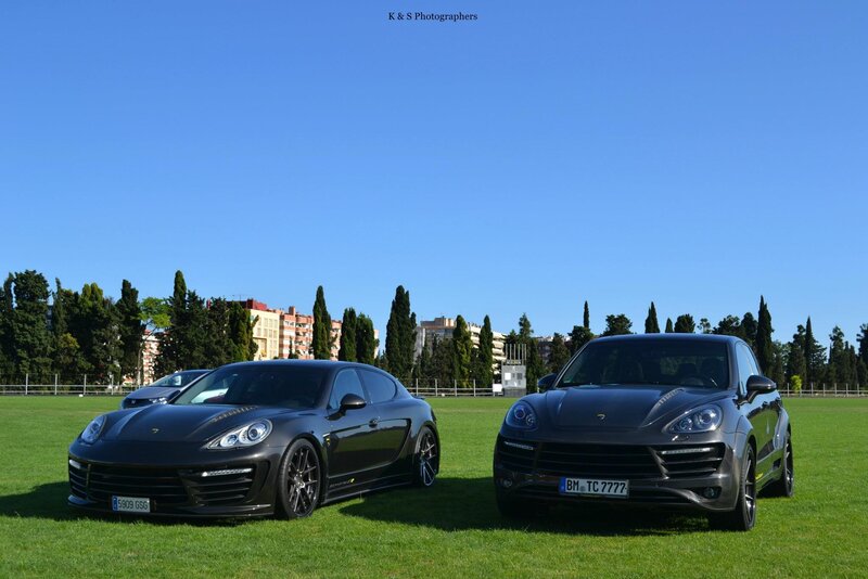 Porsche cars on a grass field