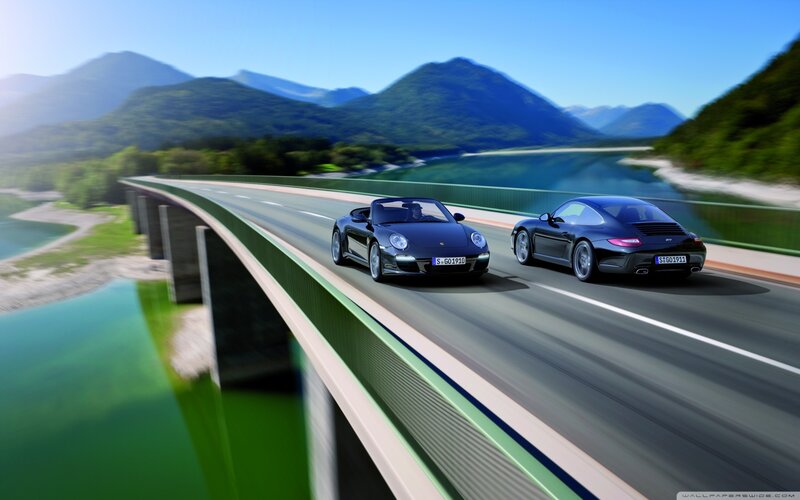 Porsche cars on a scenic bridge