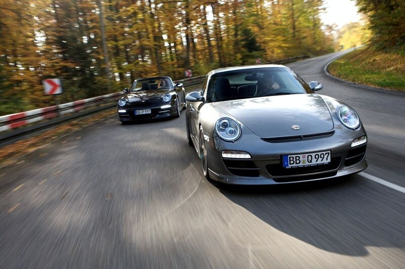 Porsche cars on a winding road