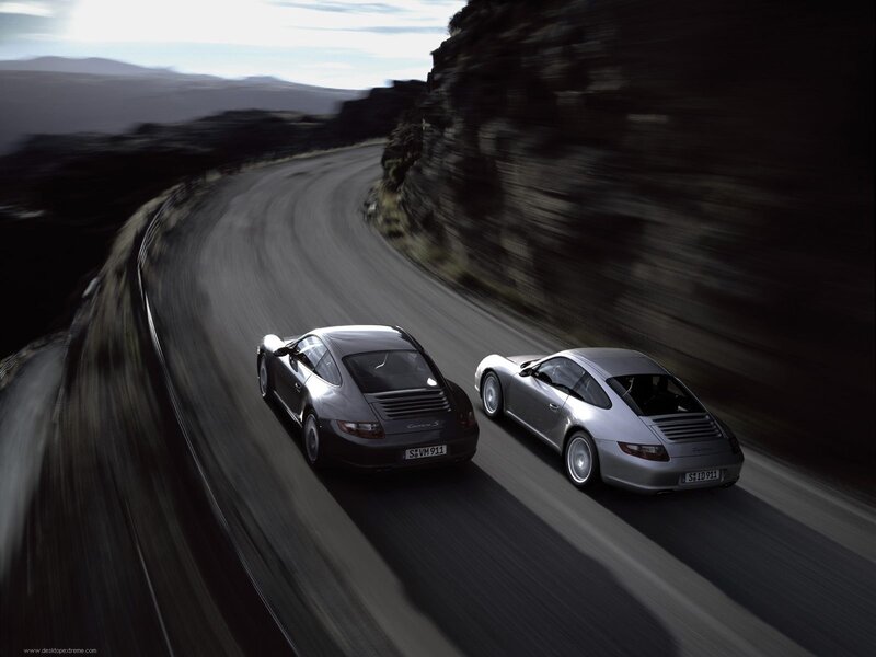 Porsche cars on winding road