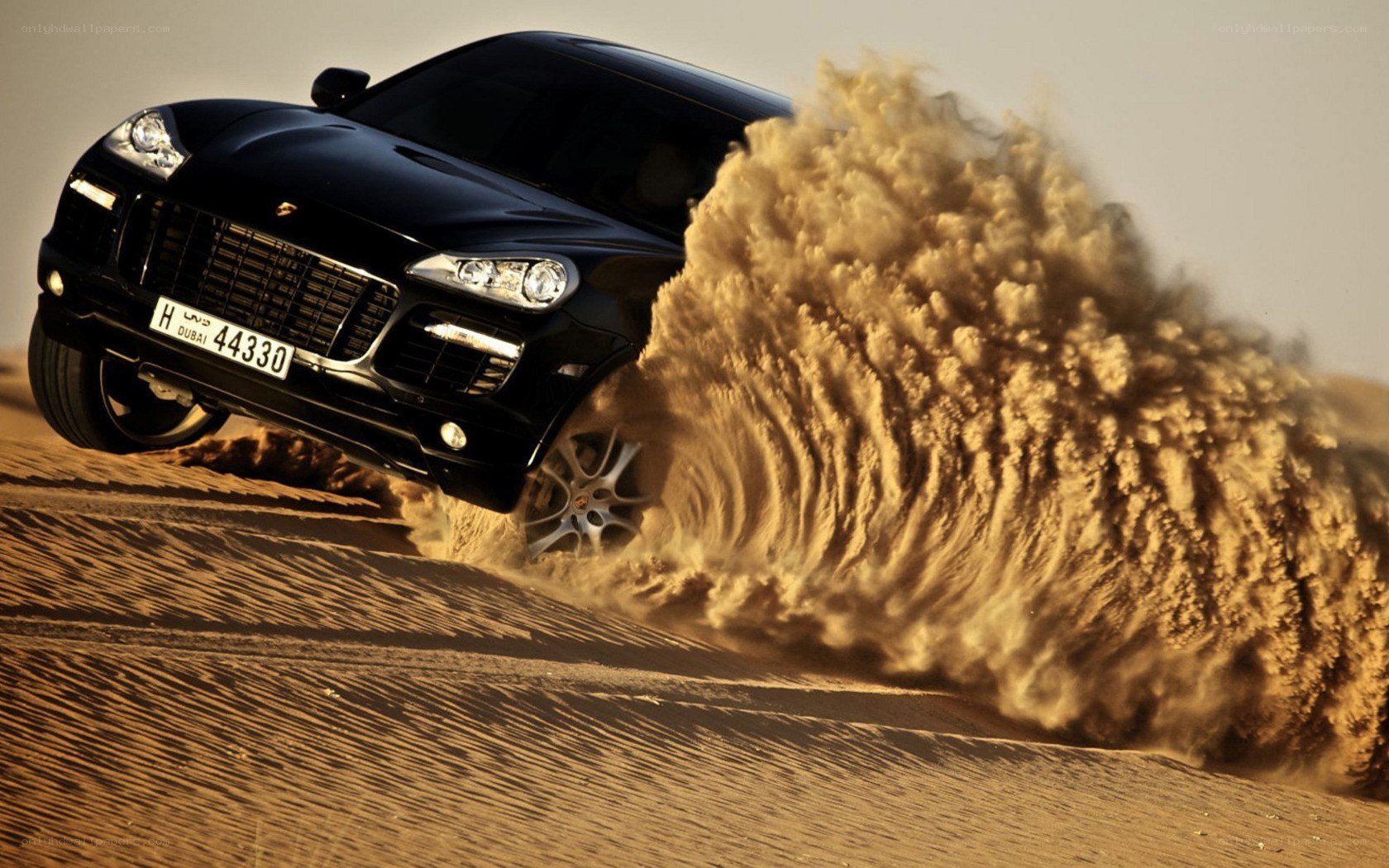 Porsche Cayenne in desert sand