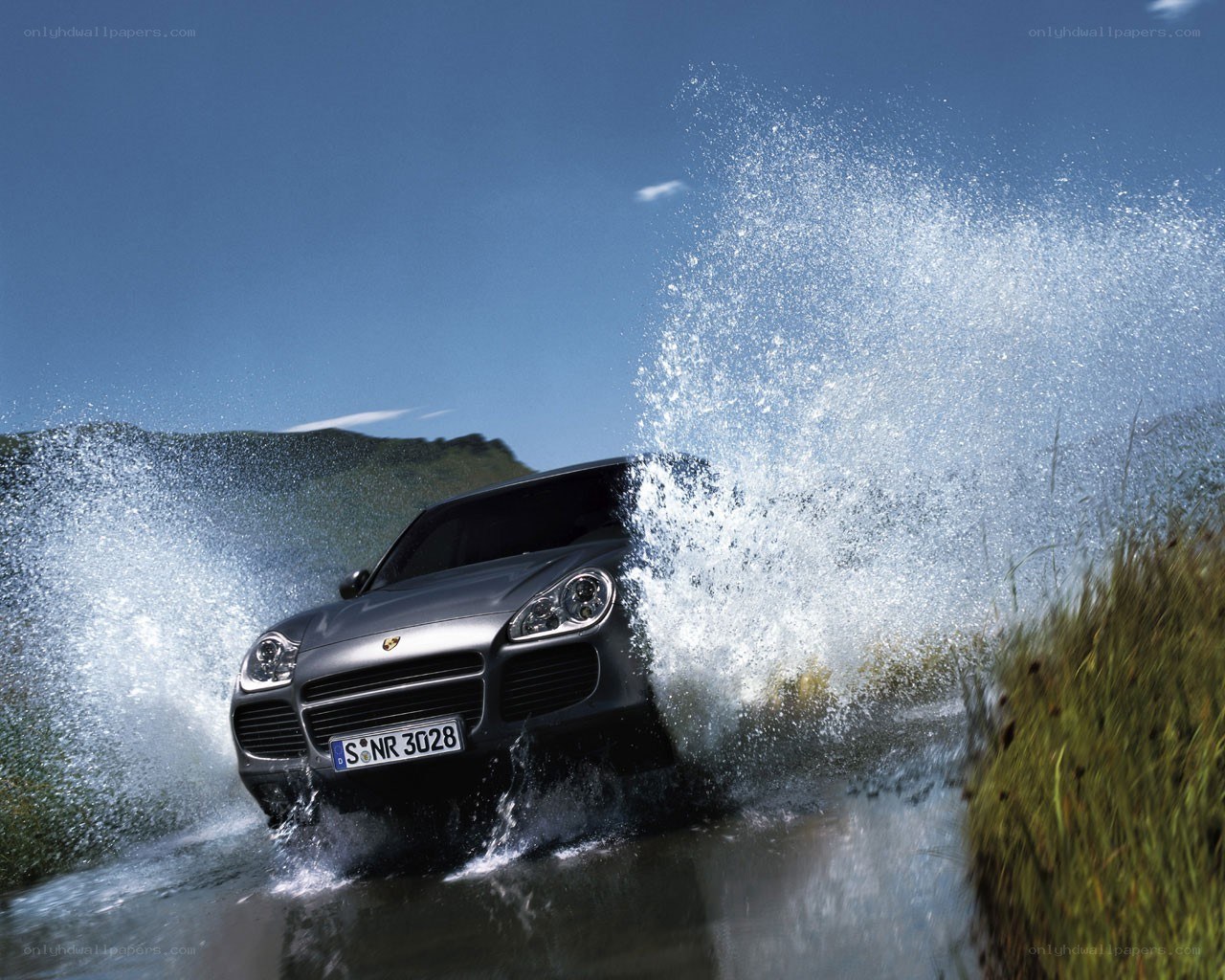 Porsche Cayenne splashing through water