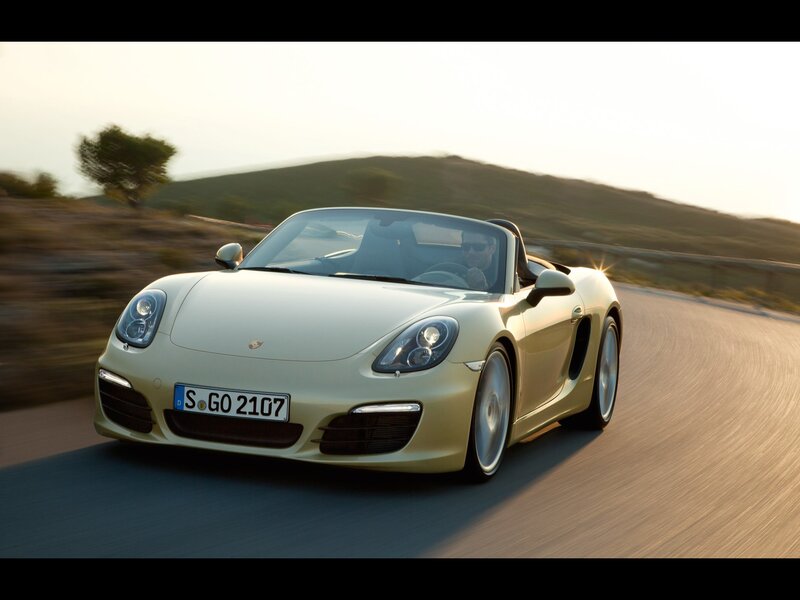 Porsche Cayman driving on a road