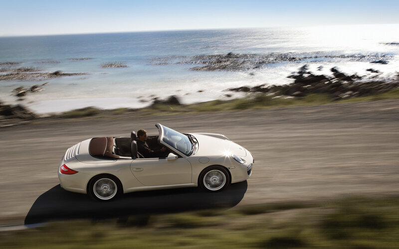 Porsche convertible on coastal road