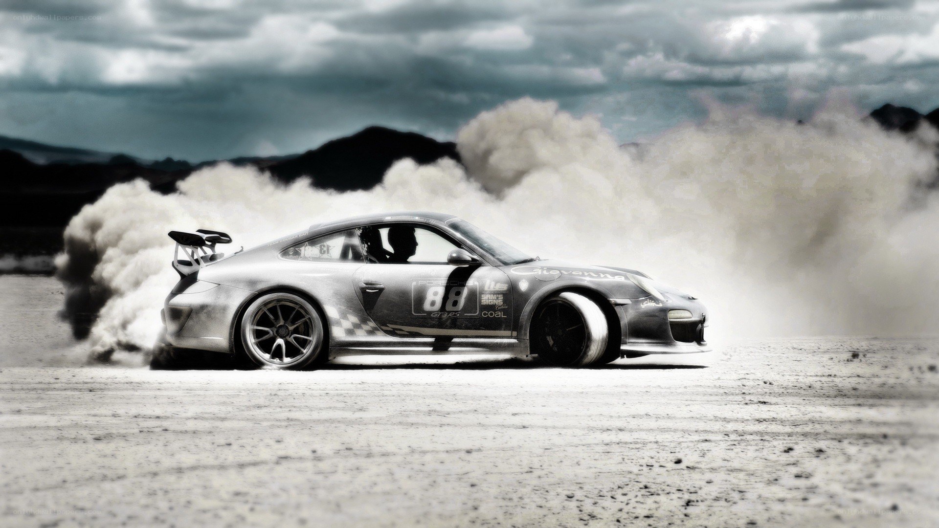 Porsche drifting in dust