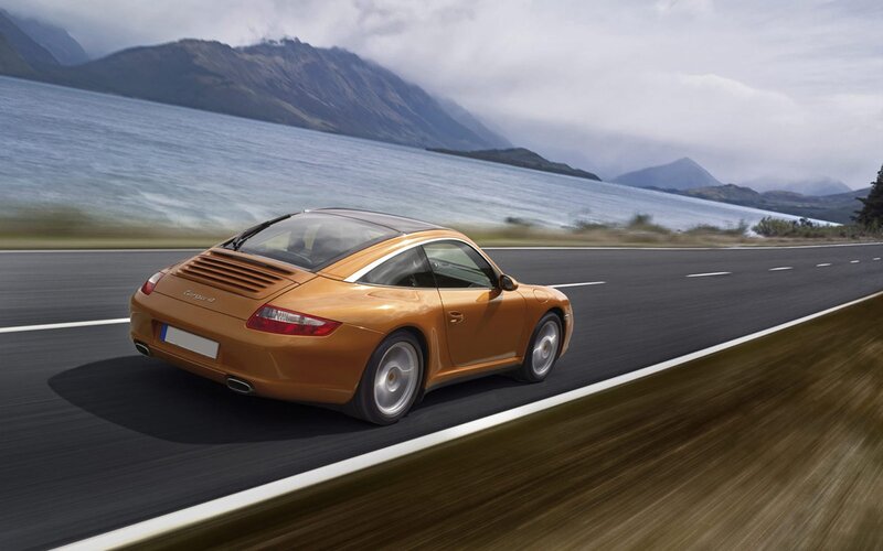 Porsche driving on a scenic road
