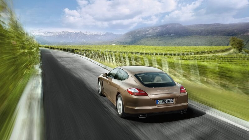 Porsche driving on a scenic road