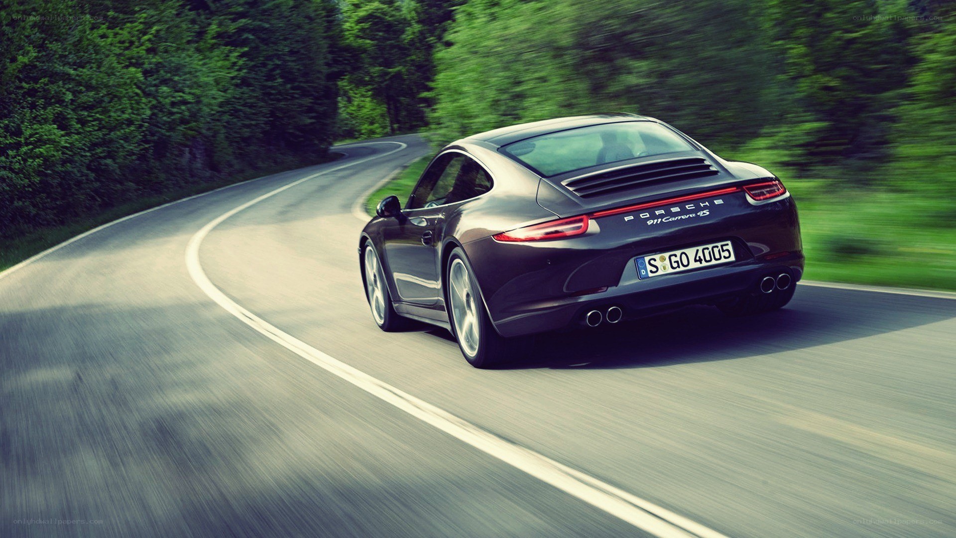 Porsche driving on a winding road