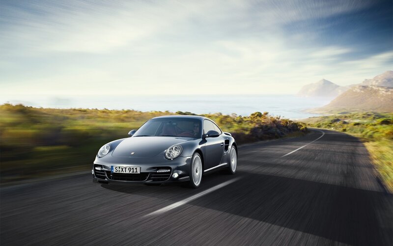Porsche driving on coastal road