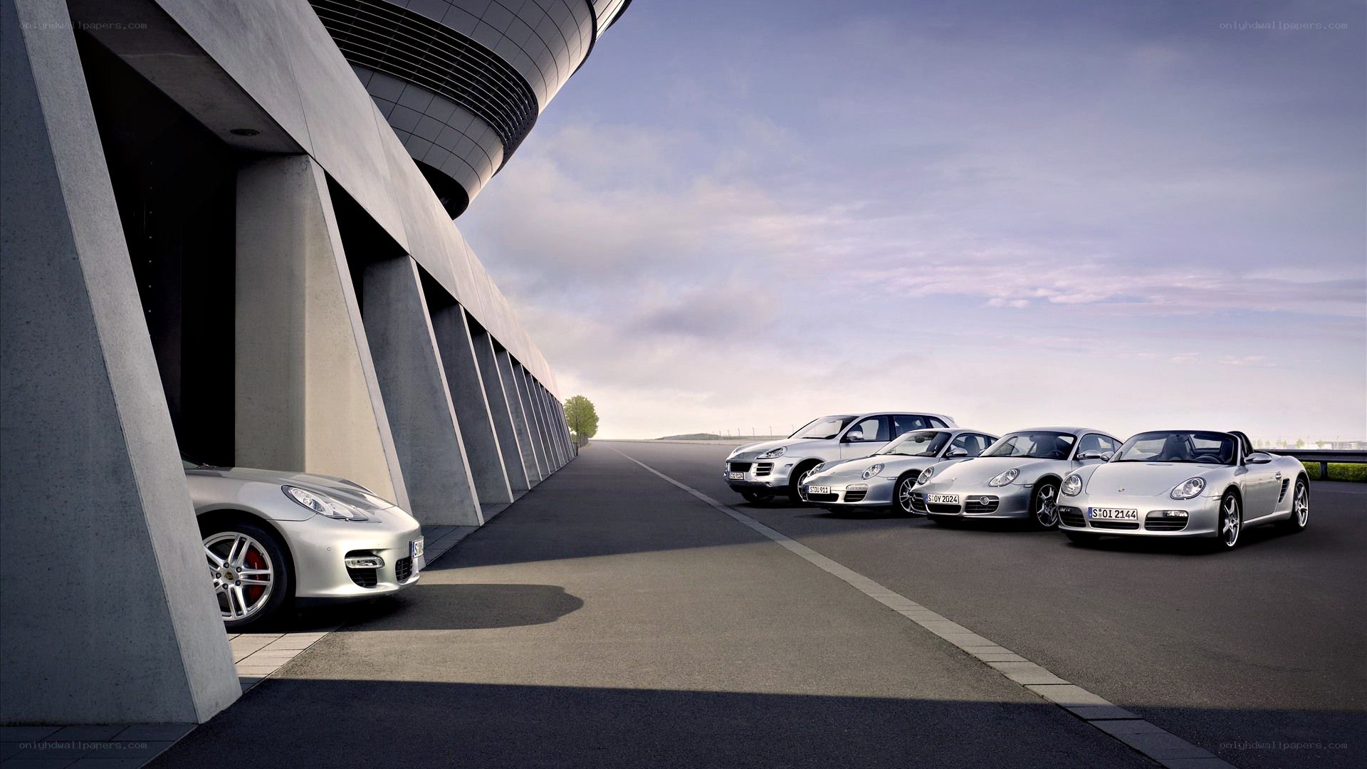 Porsche lineup at a modern facility