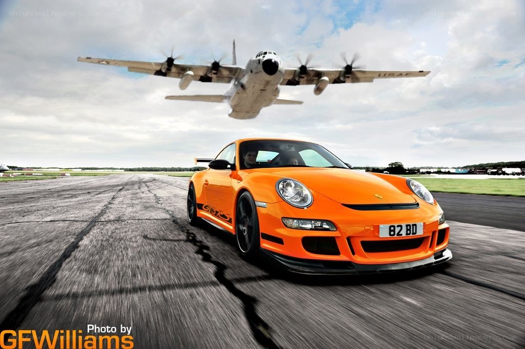 Porsche on runway with plane