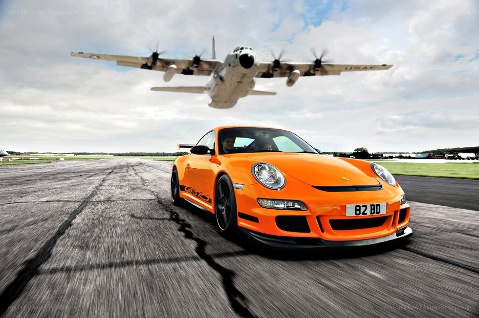Porsche on runway with plane