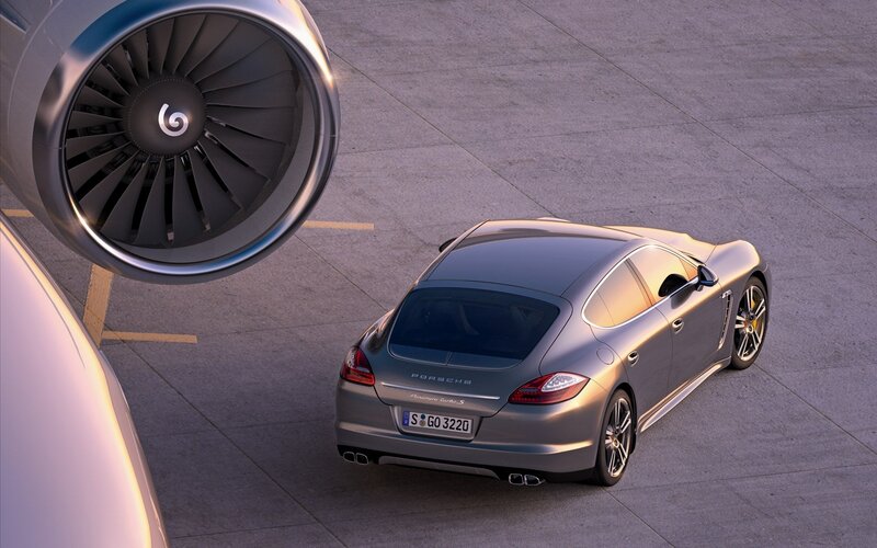 Porsche Panamera S near airplane