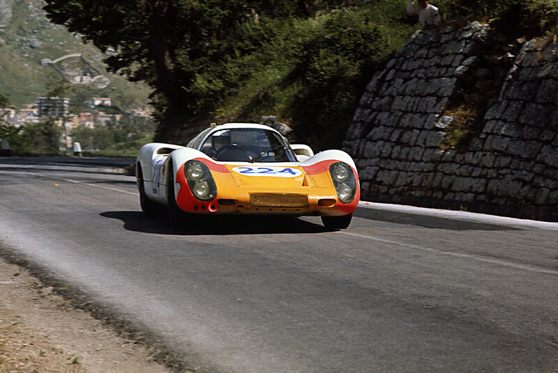Porsche race car on mountain road