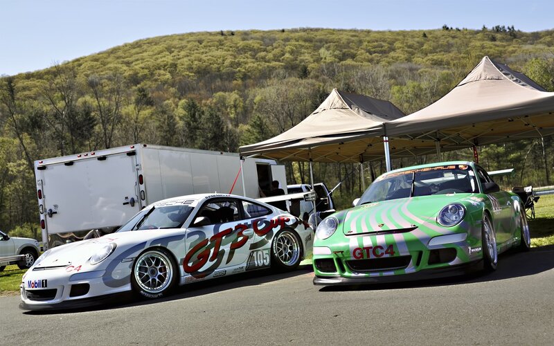 Porsche race cars at a track