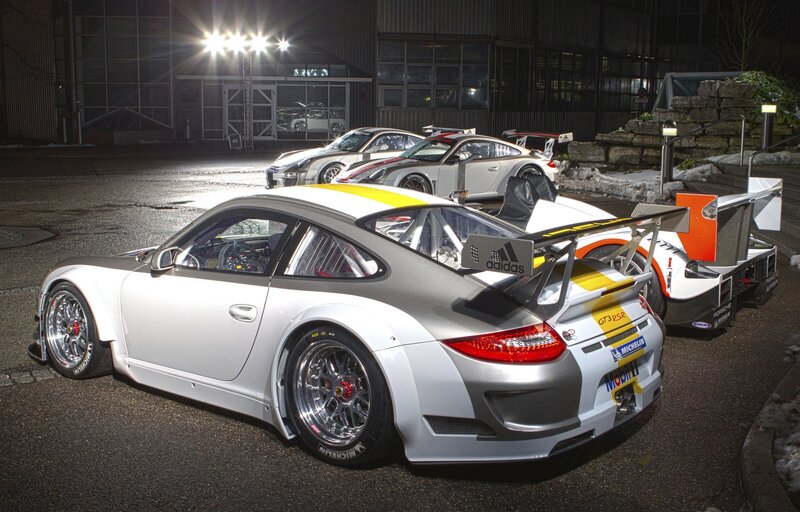 Porsche race cars at night