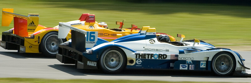 Porsche race cars on track