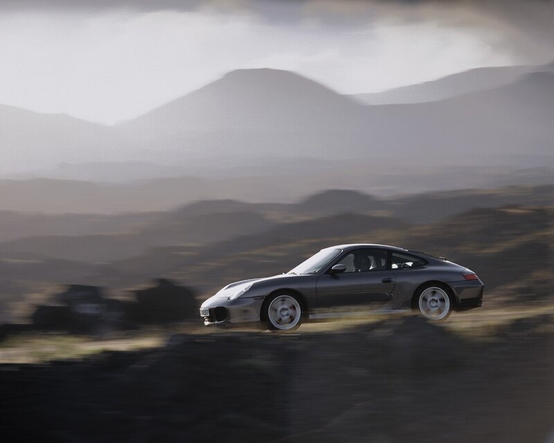 Porsche speeding on a mountain road