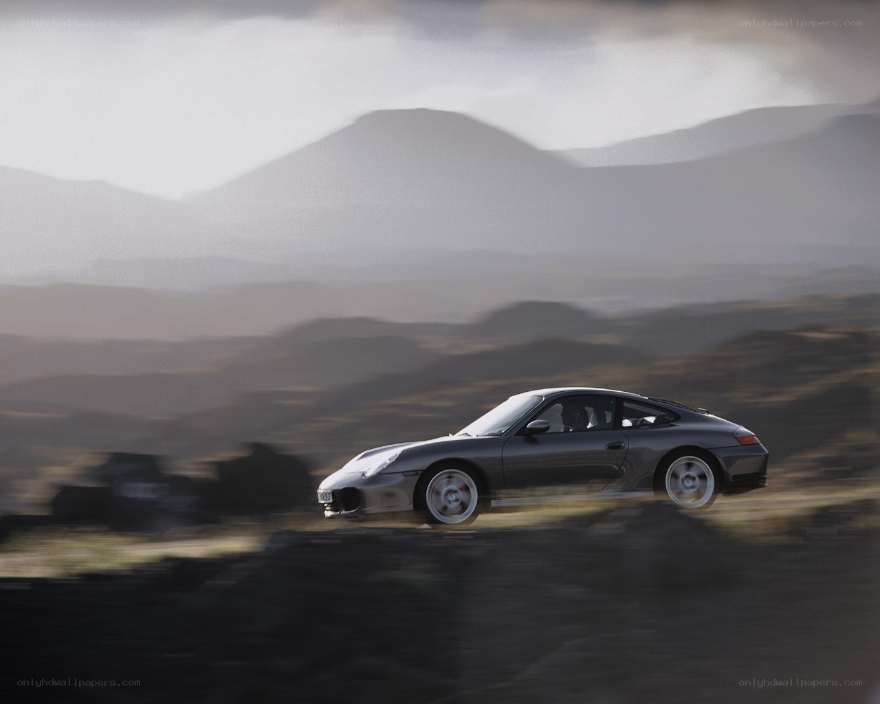 Porsche speeding on a mountain road