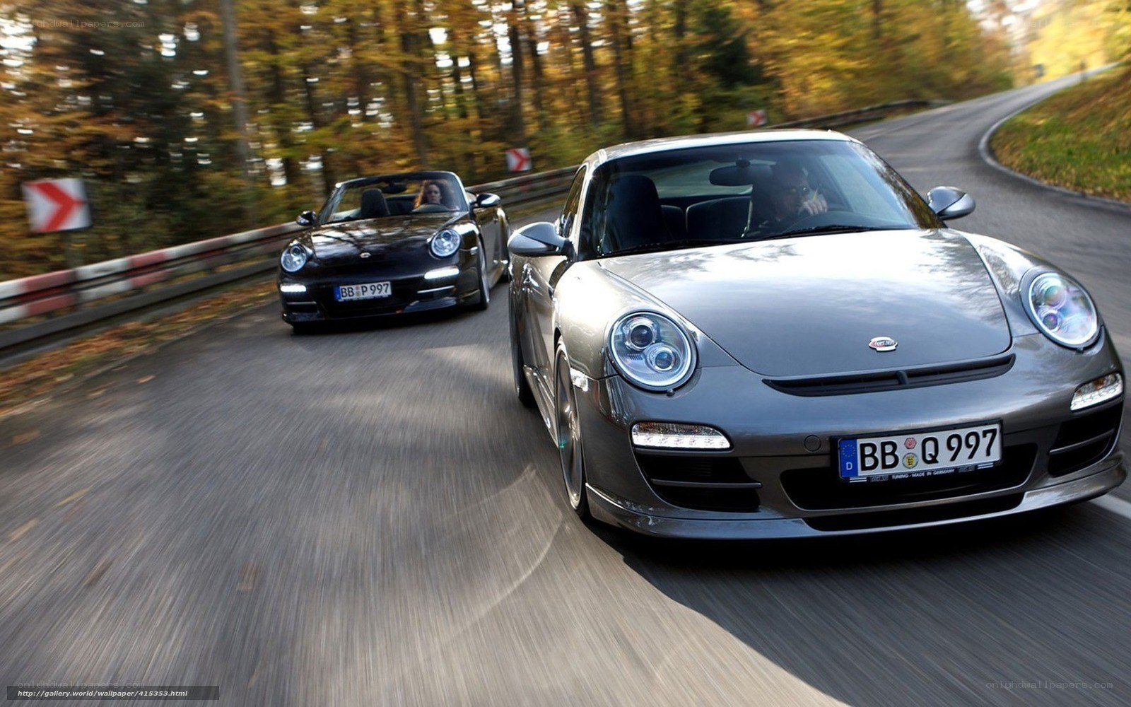 Porsche sports cars on a winding road