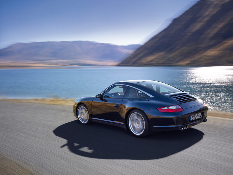 Porsche Targa driving by a lake