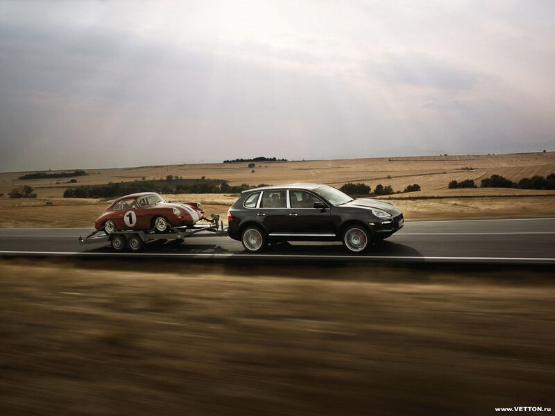 Porsche towing vintage car