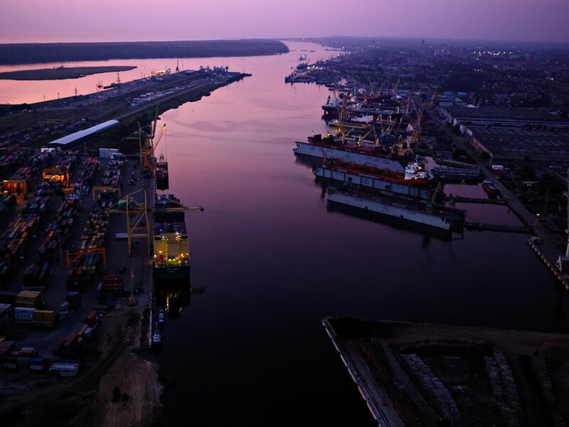 port at dusk with cargo ships