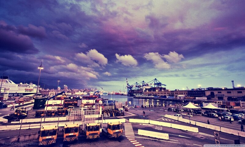 Port at dusk with cargo trucks
