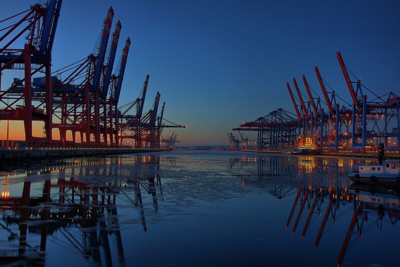 port at dusk with cranes