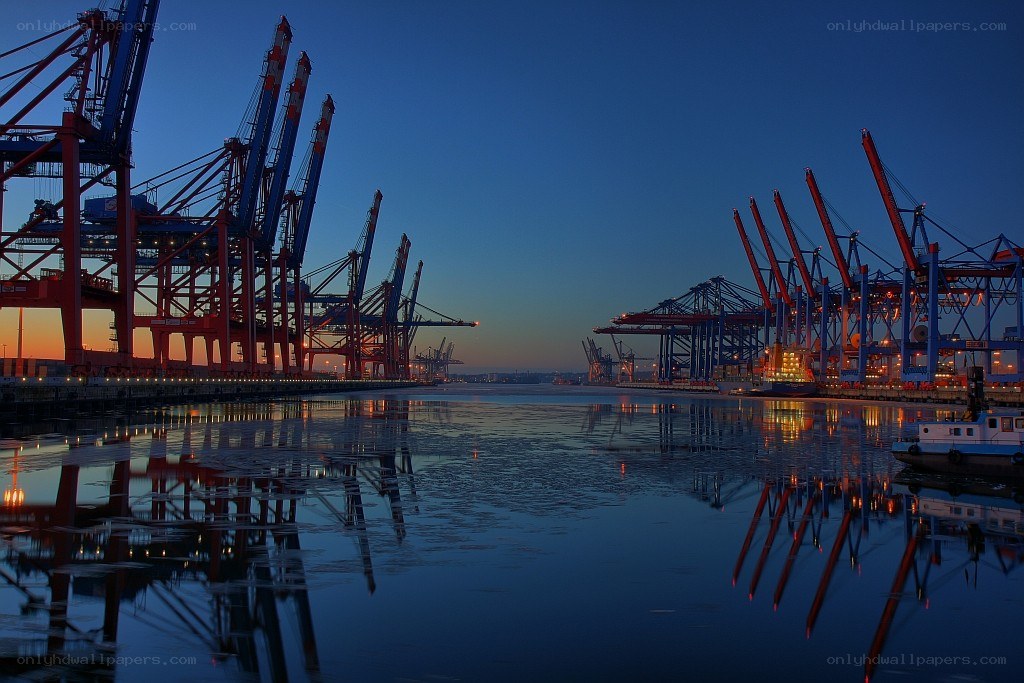 port at dusk with cranes